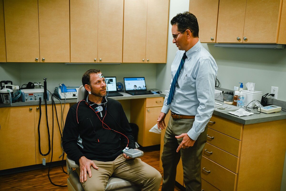 Audiologist performing balance test