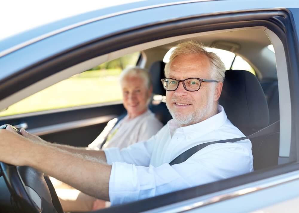 A senior couple in a car for a curbside appointment at Hearing and Balance Doctors